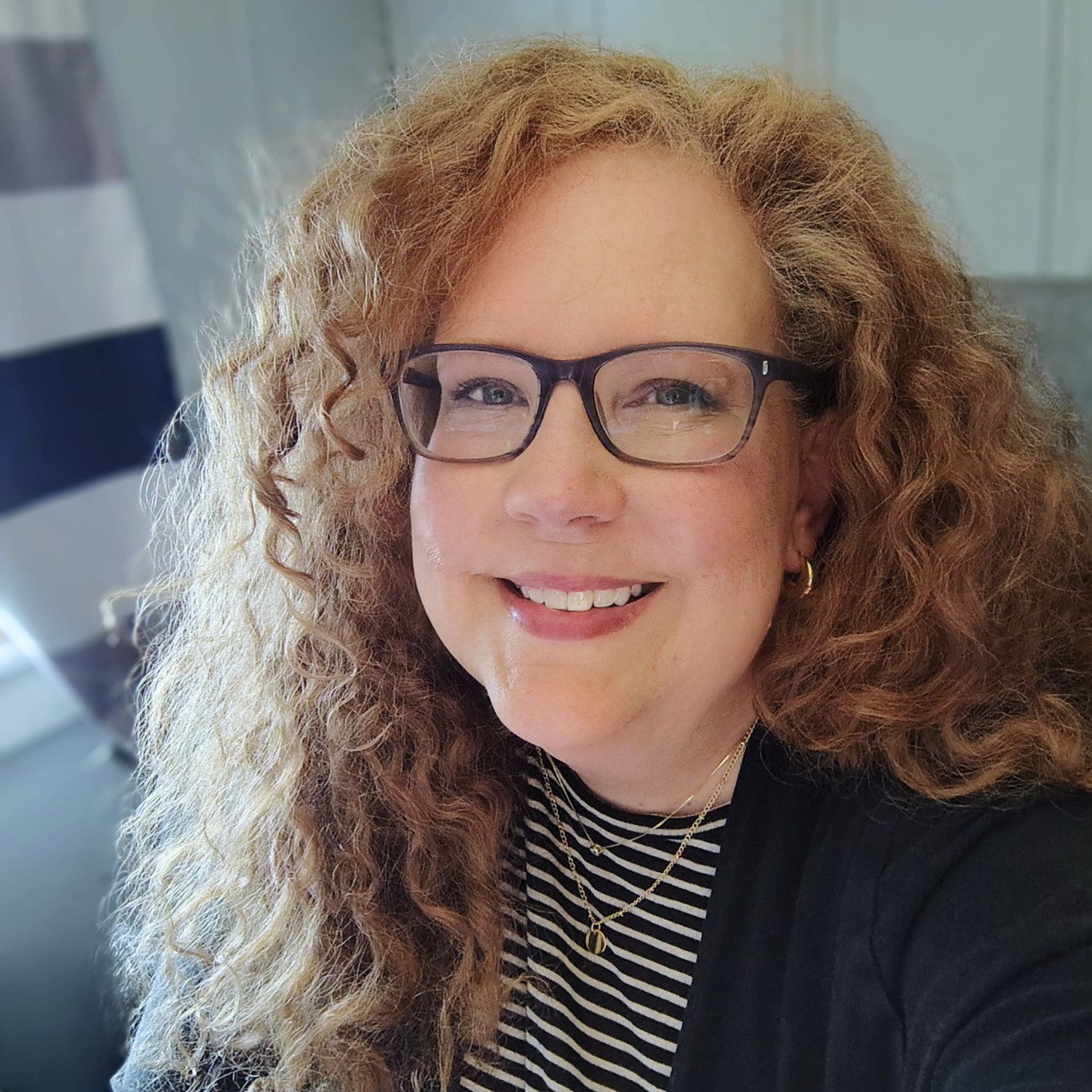 Image of Kelli Goldin, looking at the camera, smiling.